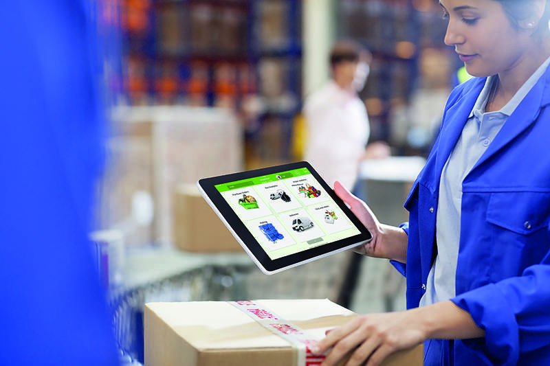 worker using digital order management in warehouse on tablet