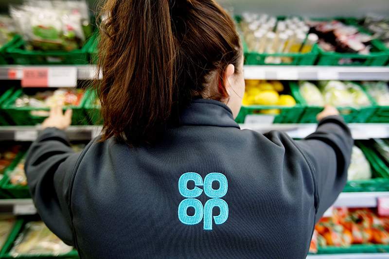 Co-op staff worker stacking shelves