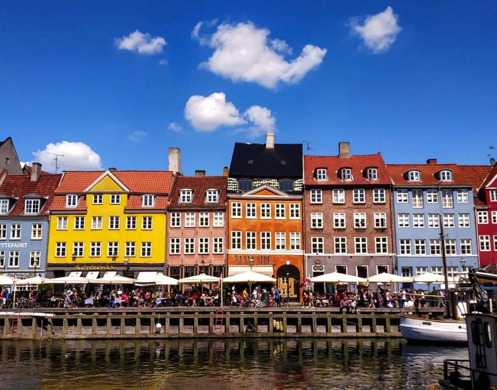 Nyhavn in Copenhagen, with blue sky and sunshine.