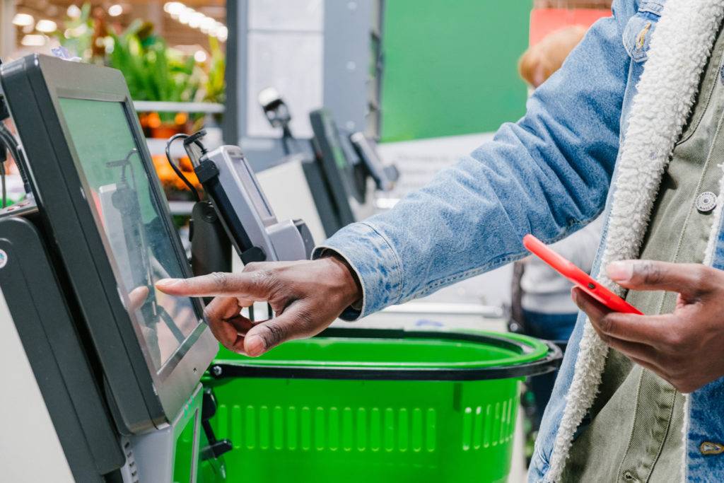 Shopper uses self-checkout technology in grocery store